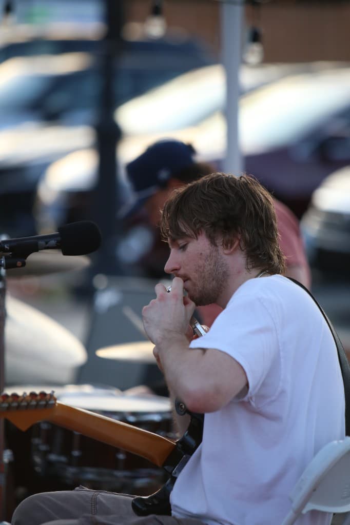 FORM guitarist preparing for an outdoor performance